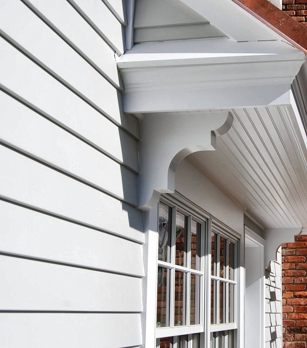 Custom scrolled brackets and beadboard ceiling under a copper-trimmed roof